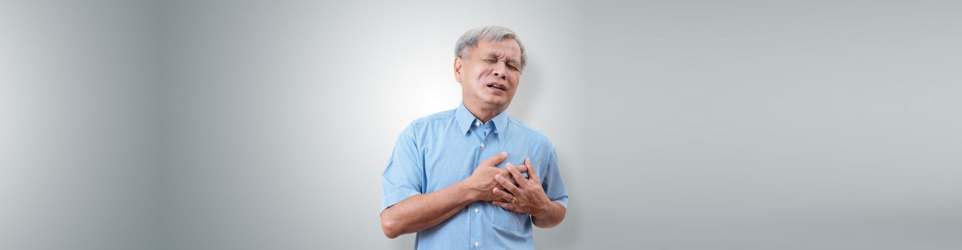 senior man clutching and having chest pain cause of heart attack